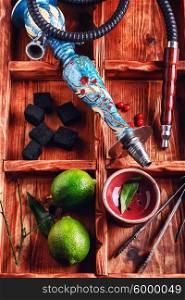 Accessories for Shisha. dismantled parts of the hookah in stylish wooden box with fruits lime