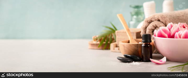 Accessories for spa procedures. Natural ingredients and flowers on blue background. Space for text