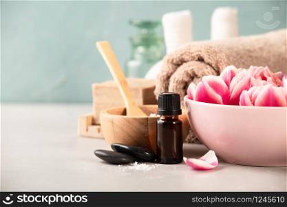 Accessories for spa procedures. Natural ingredients and flowers on blue background. Space for text