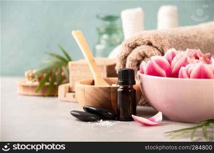 Accessories for spa procedures. Natural ingredients and flowers on blue background. Space for text