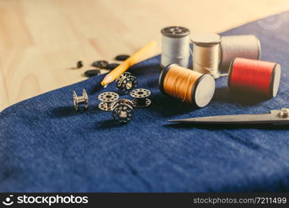 Accessories for tailoring on fabric and wooden top.