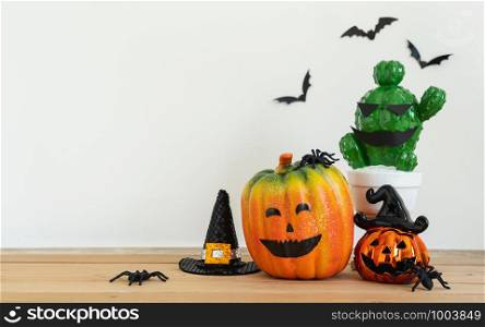 Accessories of decorations Happy Halloween day background concept.Jack O Lanterns cactus with spooky pumpkins object to party season with spider on modern rustic brown & white stone backdrop.