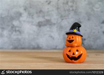 Accessories of decorations Happy Halloween day background concept.Couple jack O Lanterns with spooky pumpkins object to party season on modern brown & white stone backdrop.copy space for creative.