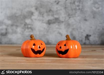 Accessories of decorations Happy Halloween day background concept.Couple jack O Lanterns with spooky pumpkins object to party season on modern brown & white stone backdrop.copy space for creative.
