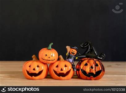 Accessories of decorations Happy Halloween day background concept.Variety of Jack O Lanterns pumpkins object to party season with spider on modern rustic brown & black stone backdrop.copy space.