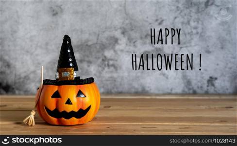 Accessories of decorations Happy Halloween day background concept.Jack O Lanterns with spooky pumpkins object with witch broom to party season on modern brown & white stone backdrop.text of season.