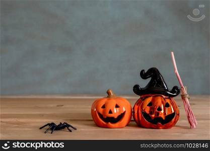 Accessories of decorations Happy Halloween day background concept.Couple jack O Lanterns with spooky pumpkins with witch broom object to party season on modern brown & white stone backdrop.