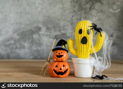 Accessories of decorations Happy Halloween day background concept.Jack O Lanterns cactus with spooky pumpkins object to party season with spider on modern rustic brown & white stone backdrop.
