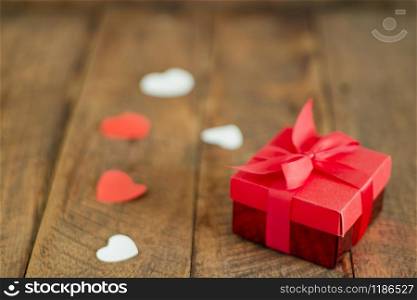 Accessories of decorations valentine&rsquo;s day background concept.Essential items colorful love shape with red gift box on modern rustic brown wooden.blank space for mock up creative design text.
