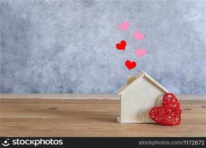 Accessories of decorations valentine&rsquo;s day holiday background concept.Essential items colorful pastel love shape with wooden house on modern rustic brown wooden.Copy space for creative design text.
