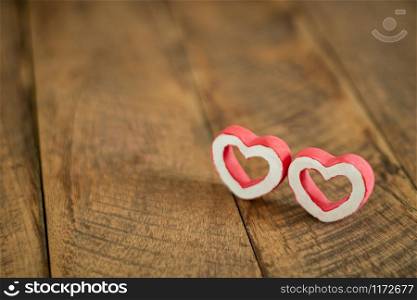 Accessories of decorations valentine&rsquo;s day holiday background concept.Essential item colorful red love couple shape on modern brown paper wallpaper.blank space for mock up creative design word.