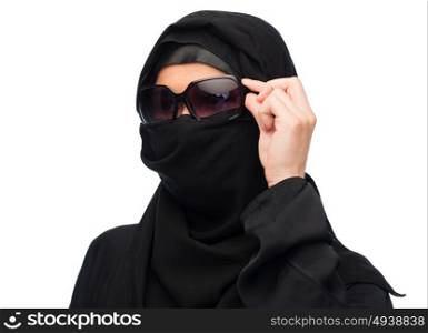 accessory, fashion and people concept - muslim woman in hijab and sunglasses over white background. muslim woman in hijab and sunglasses over white