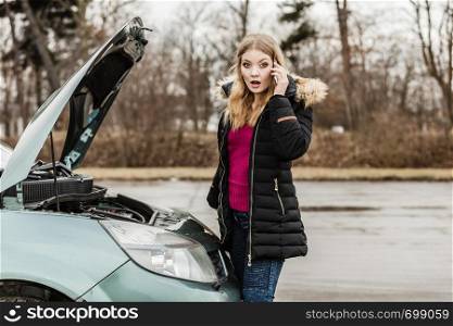 Accident and breakdowns with auto concept. Broken down car, blonde woman having problem, calling to somebody for help.. Broken down car, woman calling to somebody