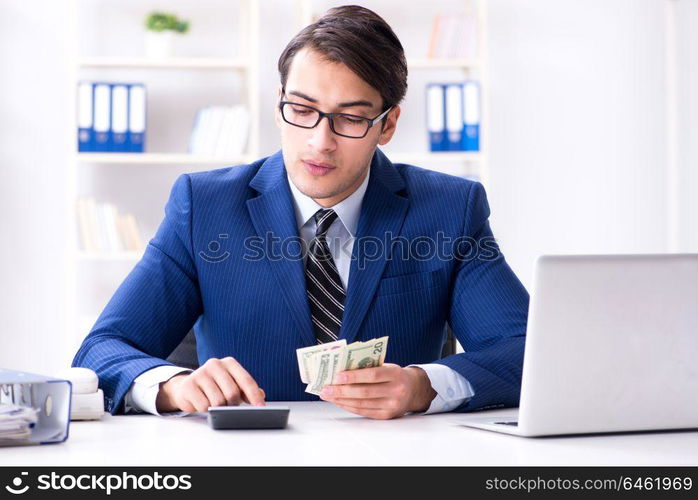 Accountant calculating dollars with calculator in office