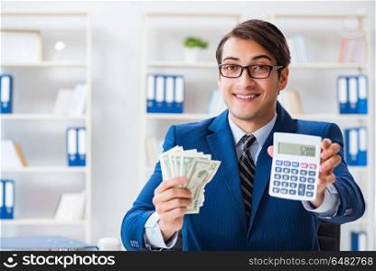 Accountant calculating dollars with calculator in office