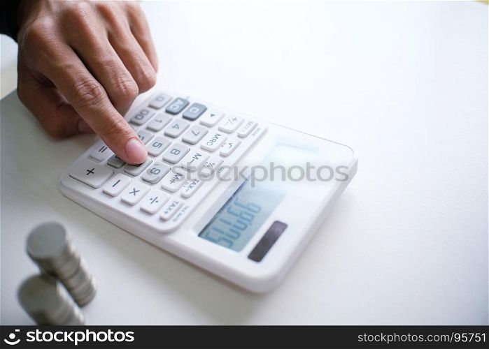 Accountant verify the business and saving money stacking gold coins with calculator. Accountancy Concept.