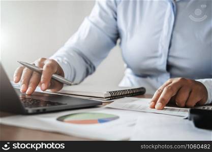 accountant working in office using computer laptop on desk. finance and accounting concept