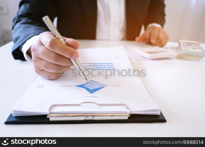 Accountant Working man uses calculator with Spreadsheet document, information financial concept