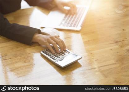 accountant working with calculator and computer laptop on office desk