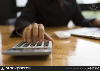 accountant working with calculator and computer laptop on office desk