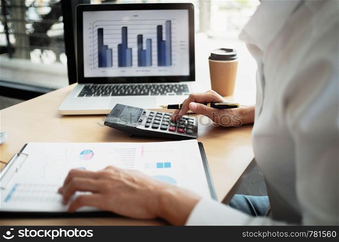 Accountant working with data documents calculating on business report.