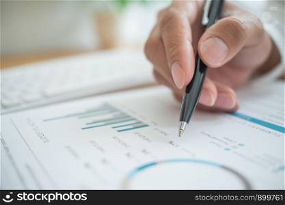 Accountant working with data documents calculating on business report.