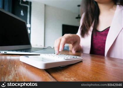 Accountant Working women use calculator with Spreadsheet document information financial concept.