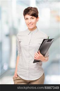 Accountant young girl with a folder in the office