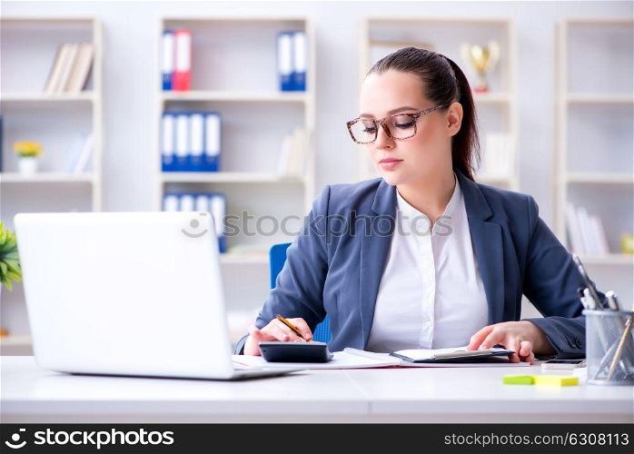 Accountantworking in the office with calculator