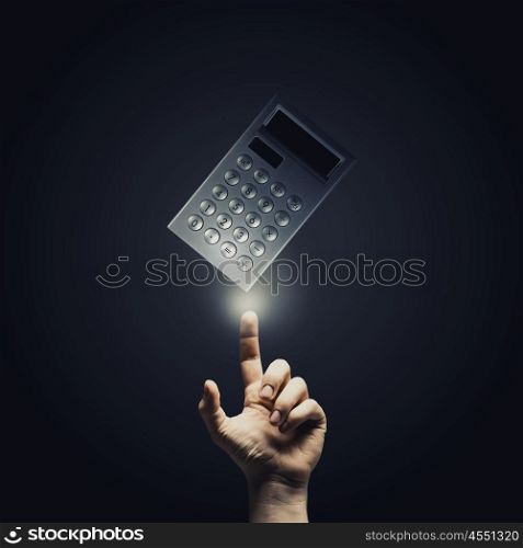 Accounting concept. Close up of male hand pointing at calculator sign