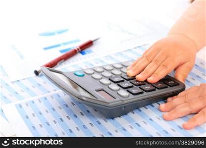 Accounting concept. Kid hands and calculator.