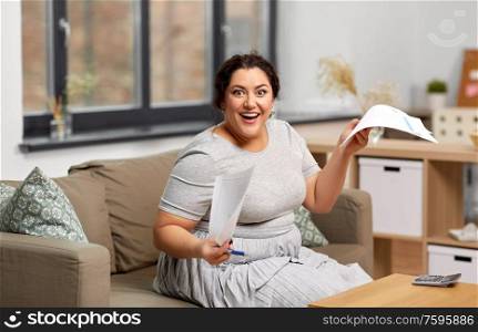 accounting, taxes and people concept - happy smiling woman with papers and calculator at home. happy woman with papers and calculator at home