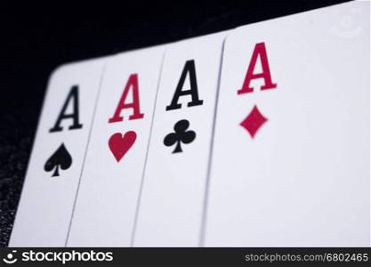 ace four of a kind poker card on dark black background