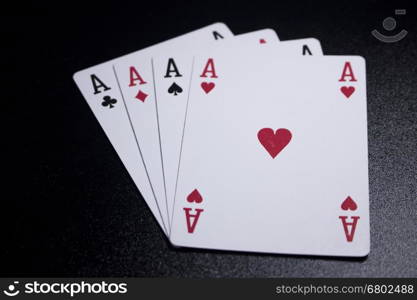 ace four of a kind poker card on dark black background