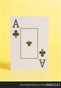 Ace of Clubs playing card on yellow background
