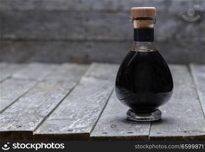 Aceto balsamico on old gray wood.. Aceto balsamico on old gray wood