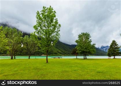 Achensee ( Lake Achen) summer landscape with green meadow and wooden moorage (Austria).
