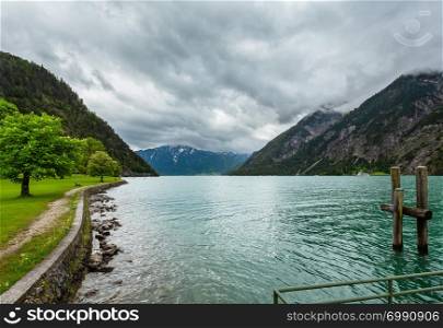 Achensee ( Lake Achen) summer landscape with green meadow and wooden moorage (Austria).