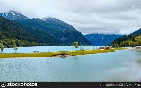 Achensee ( Lake Achen) summer landscape with wooden bridge and clouds reflection on water surface(Austria).