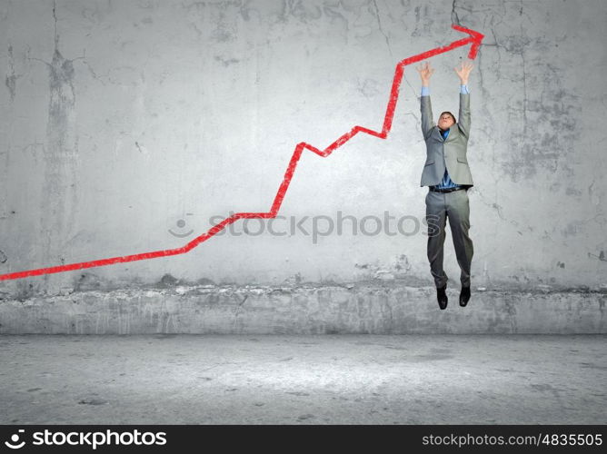 Achievement in business. Image of jumping businessman trying to catch arrow of graph