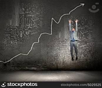 Achievement in business. Image of jumping businessman trying to catch arrow of graph