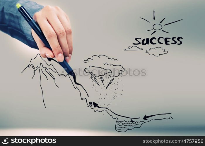 Achievement of success. Close up of businessman hand drawing business sketches
