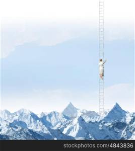 Achieving the top. Businesswoman standing on ladder high above mountains