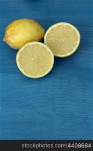 Acid and yellow fruit. Lemons on a blue wood