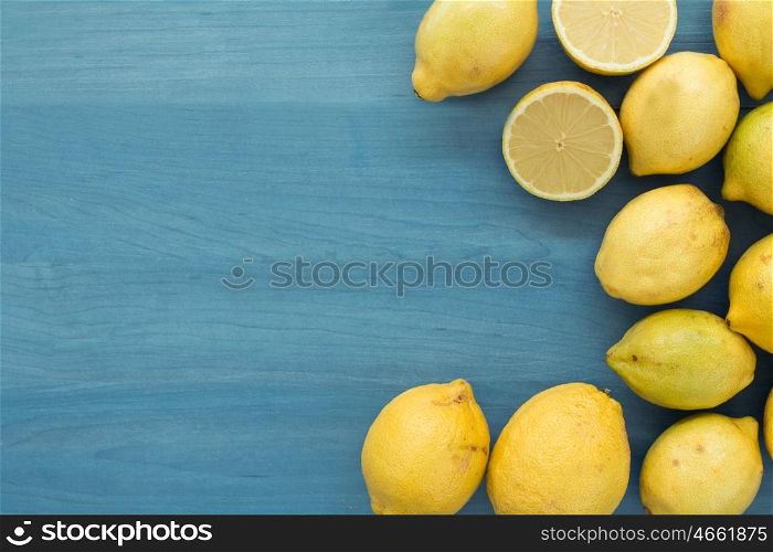Acid and yellow fruit. Lemons on a blue wood