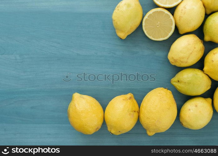 Acid and yellow fruit. Lemons on a blue wood