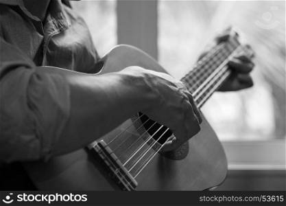 Acoustic guitar guitarist playing. Musical instrument with performer hands.