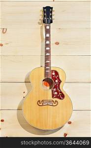 Acoustic guitar with label on a wood grain wall