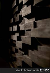 acoustic materials, texture, interior and soundproofing concept - wooden brick wall decoration at sound recording studio. wooden wall decoration