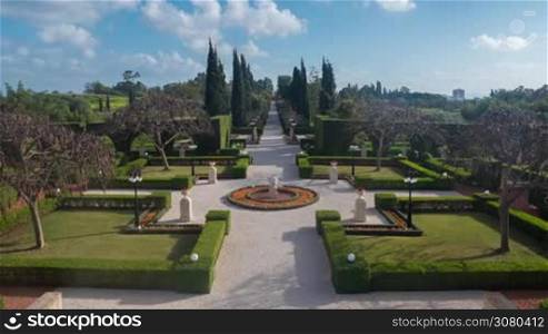 ACRE, ISRAEL- MARCH 12, 2017: Timelapse shot of tourists walking along the paths of beautiful green Bahai garden. It was inscribed on the World Heritage List in July 2008